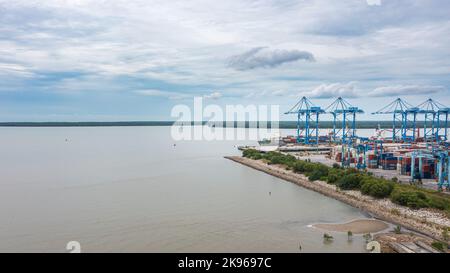 Klang, Malaysia - October 09, 2022: Cranes at the port Klang near Kuala Lumpur. Container crane at Klang Harbor. Aerial view on a container ship which Stock Photo