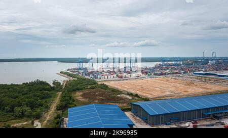 Klang, Malaysia - October 09, 2022: Cranes at the port Klang near Kuala Lumpur. Container crane at Klang Harbor. Aerial view on a container ship which Stock Photo