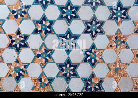 Closeup view of geometric decor with ancient white and blue tiles in flower and star pattern on Kok Gumbaz mosque wall, Istaravshan, Sughd, Tajikistan Stock Photo