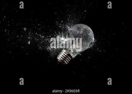 light bulb shattering on black Stock Photo