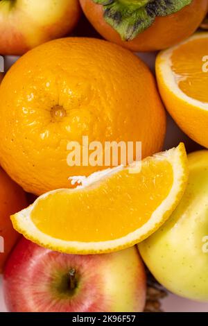 Oranges, orange slices and apples close-up view from above. Stock Photo