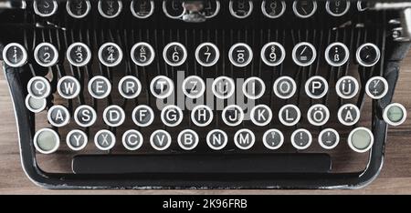 top down view on old vintage typewriter keyboard on wooden table Stock Photo