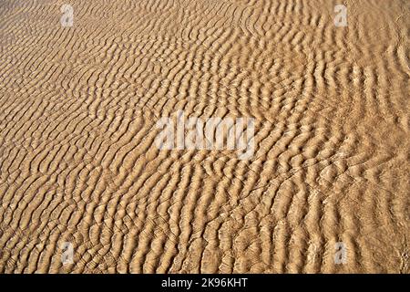 Sand rills on a tidal beach Stock Photo