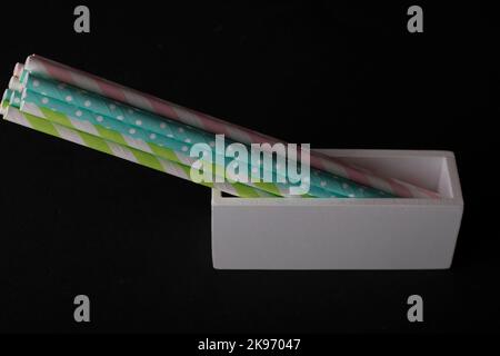 Multicolored cocktail straws on a black background Stock Photo