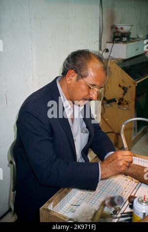 Kuwait City Kuwait Worker In Gold Market Using Soldering Pen Stock Photo