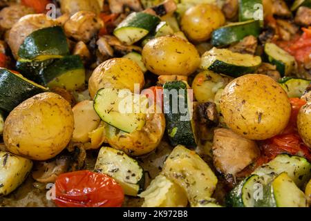 Close up of oven roasted vegetables on a baking tray Stock Photo