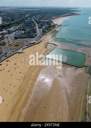 A pool and city buildings on the sandy shore at a beautiful beach Stock Photo