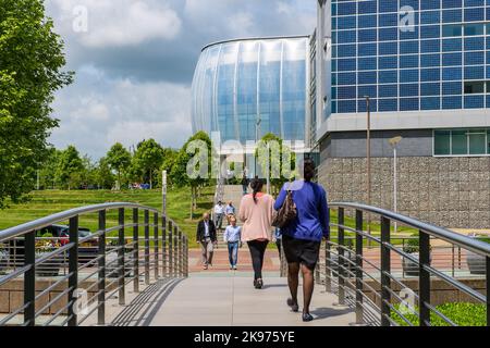 Office workers walking across Footbridge Stock Photo