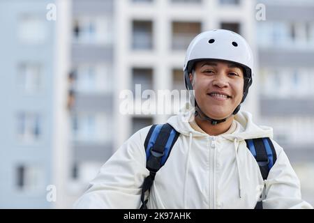 Portrait of smiling woman working in food delivery service, copy space Stock Photo