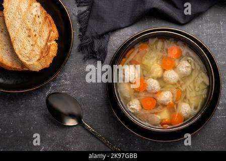 Food photography of soup with meatballs, chicken, vegetables, carrots, cabbage, potatoes, toast Stock Photo