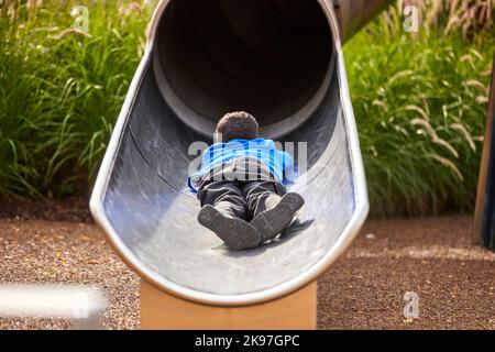 Mayfield Park Manchester, child playing on the slide Stock Photo