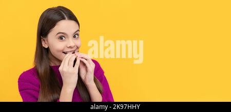 Happy kid sweet-tooth enjoy eating tasty chocolate slab yellow background, snack. Horizontal poster of isolated child face, banner header, copy space. Stock Photo