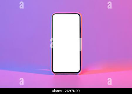 Modern phone with blank white screen, isolated on neon background Stock Photo