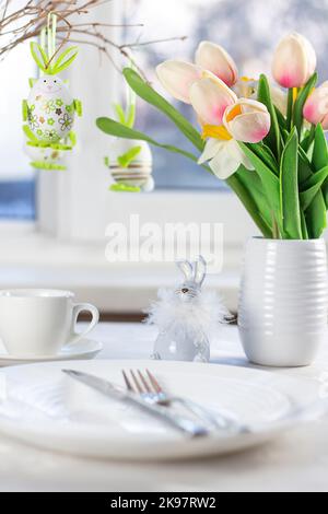 Easter table setting. Easter dinner with colorful Easter eggs. Easter background Stock Photo