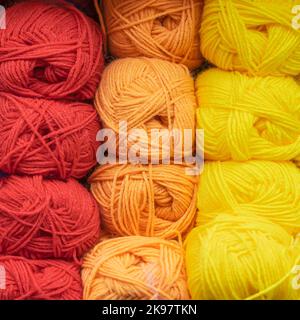 Skeins of multicolored and bright woolen threads, yarn for knitting close-up Stock Photo