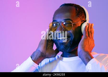Closeup of happy middle aged black man listening to music Stock Photo