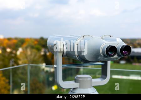 The binoculars are mounted on a solid, rotating column. Photo taken in natural, soft light. Stock Photo