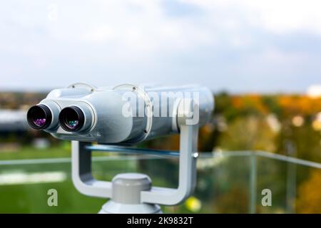 The binoculars are mounted on a solid, rotating column. Photo taken in natural, soft light. Stock Photo