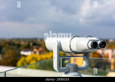 The binoculars are mounted on a solid, rotating column. Photo taken in natural, soft light. Stock Photo