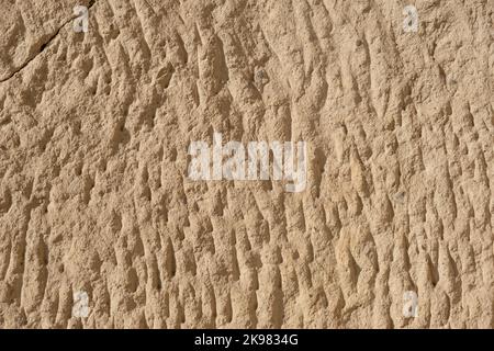 Detailed textured background of sandstone old wall with cracks light yellow colored Stock Photo