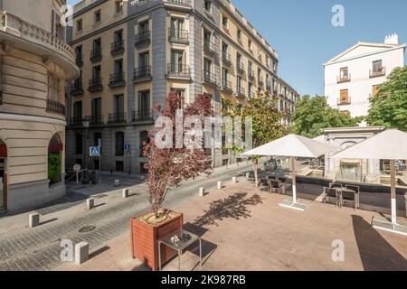 Central square in Madrid with many Facades of urban residential buildings of old construction with a lot of stone and metal Stock Photo