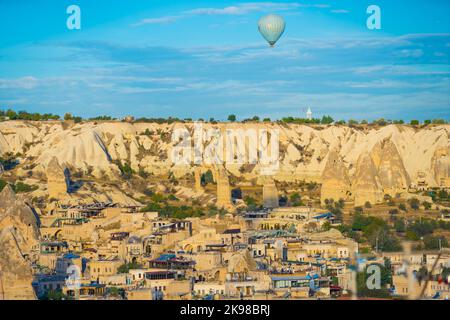 Stunning panoramic shot of Turkish town of Cappadocia know for its amazing rock formations with ancient caves and organizing hot air balloon trips over the city. Vivid blue sky. Unconventional city. High quality photo Stock Photo