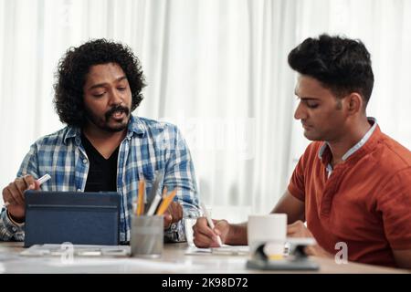 Product manager and software developer discussing project of new application they are working on Stock Photo