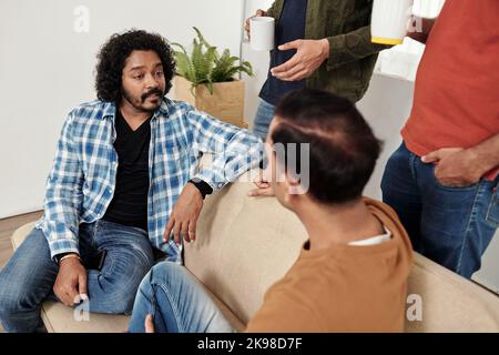 Team leader taking to developers during coffee break Stock Photo
