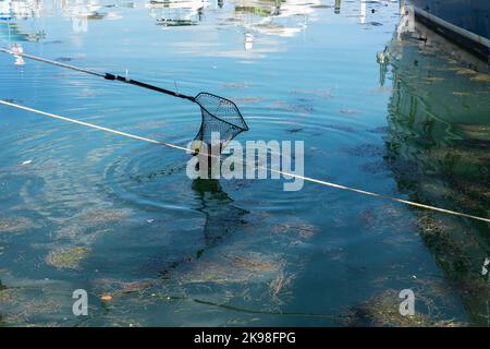 green blue fishing net with floating buoys and thick white ropes