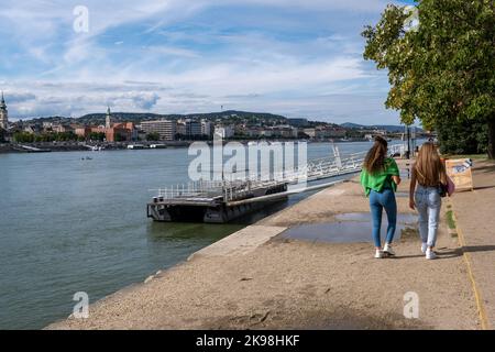 Budapest, Hungary - 1st September 2022: People walking on the promenade along the Danube River Stock Photo