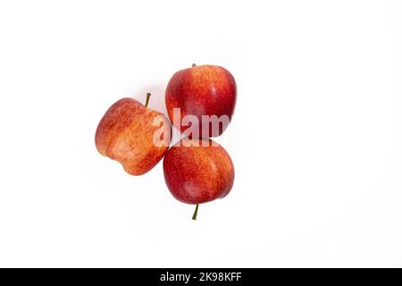 Three apples on a white background. Three sweet red apples on a seamless white background Stock Photo