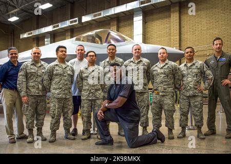 Herschel Walker, former professional athlete, takes a group photo with Airmen at Luke Air Force Base in Maricopa County, Arizona on October 3, 2017. Walker was visiting the base to speak to the Airmen about resiliency. (USA) Stock Photo