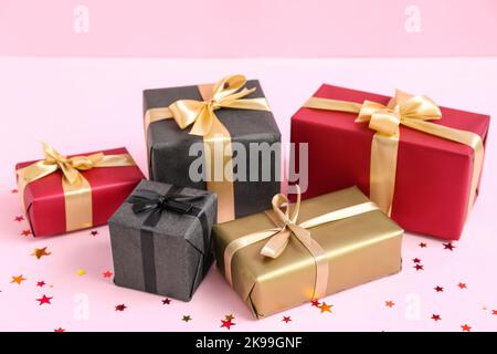 Gift boxes on pink background. Black Friday sale Stock Photo