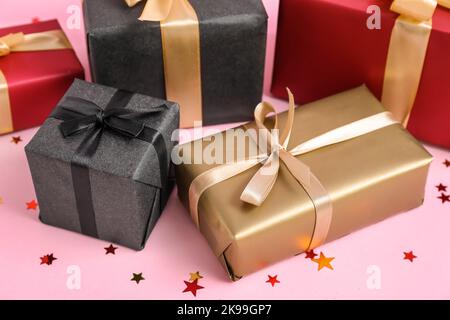 Gift boxes on pink background. Black Friday sale Stock Photo