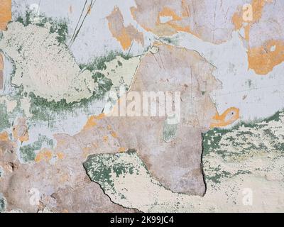 Multi Colored layers of old plaster. Texture of rough cracked pink stucco texture background. Decorative plaster on the wall. Stock Photo
