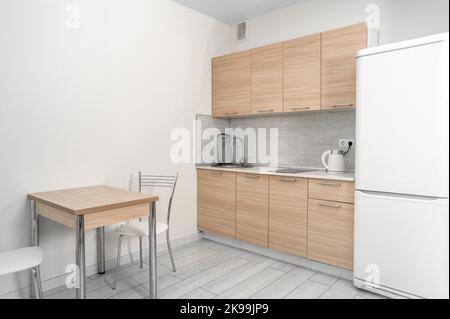 small economical kitchen living room background. Dinning room backdrop. bright clean modern small kitchen with fridge Stock Photo