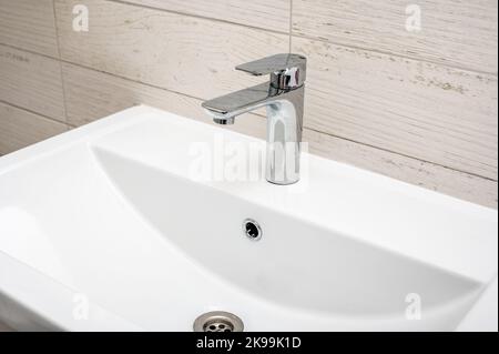 Sink in bathroom. Modern bathroom faucet. Bathroom interior with white sink and faucet. disinfection and hygiene concept Stock Photo