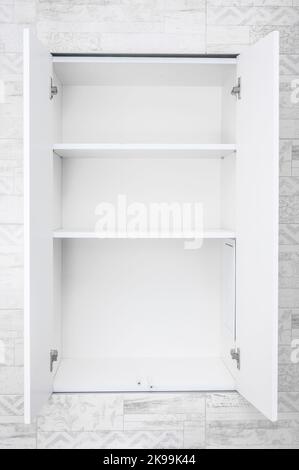 Mockup Empty white open cabinet with shelves in bathroom. shelves for product display, clean white cabinet, light grey wall paint, white wood. vertica Stock Photo
