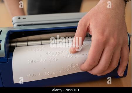 Blind man using braille typewriter.  Stock Photo