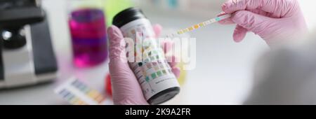 Scientist hold litmus test paper for soil analysis, litmus paper show acidity, chemical analysis Stock Photo