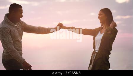 Lets dance the dance of lovers. a happy young couple dancing together outdoors. Stock Photo