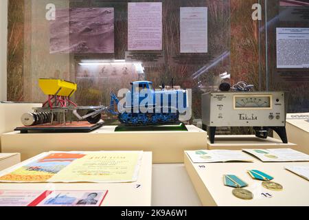 A display of Soviet, Russian, USSR, CCCP era models of farming equipment and medals. At the National Museum of the Republic of Kazakhstan in Astana, N Stock Photo