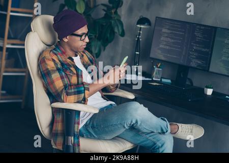 Profile photo of focused concentrated professional hacker sit chair use telephone workstation indoors Stock Photo