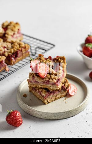 Two pieces of tasty oatmeal crumble strawberry bars on the plate Stock Photo