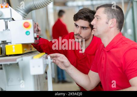 two workers checking parameters of pressure Stock Photo