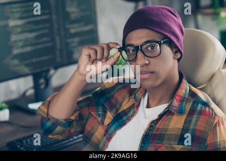 Photo of confident cool guy dressed eyewear hat working front end engineer modern device indoors workstation workshop home Stock Photo