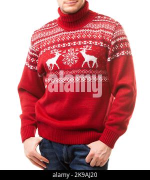 Young man wearing red knitted Christmas turtleneck sweater of traditional design with moose or elk ornament (aka Ugly Sweater) on a white background Stock Photo