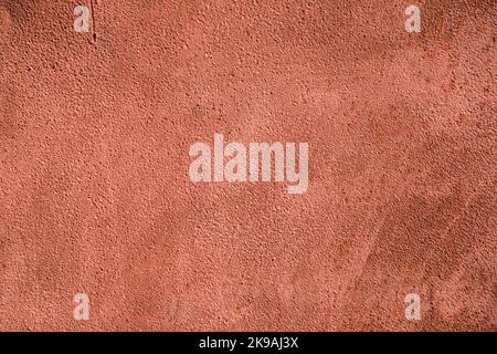 Detail of plastered and painted facade wall of house closeup as colored background Stock Photo