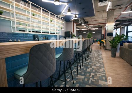 Creative zoning in coworking space, stylish bar area, clean empty space Stock Photo