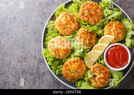 Healthy meatballs with cheese, carrots, zucchini and herbs close-up in a plate on the table. Horizontal top view from above Stock Photo